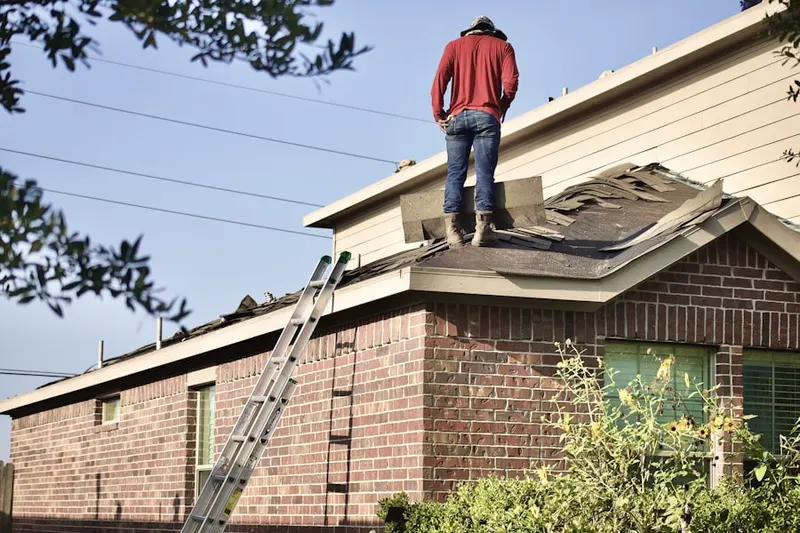 Professional roofer working on a residential roof in North Wrigley